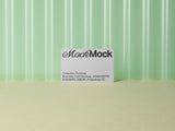 Business card mockup on a green corrugated plastic background.