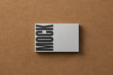 Business card mockup on a cardboard background top view.