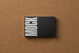 Business card mockup on a cardboard background top view.