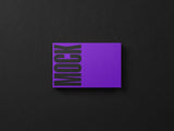 Business card mockup on a black paper background top view.