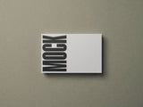Business card mockup on a grey paper stock background top view.
