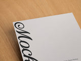 Poster/letterhead mockup on a wooden background top view.