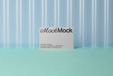 Business card mockup on a corrugated plastic background top view.