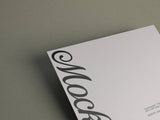 Poster/letterhead mockup on a grey paper stock background top view.