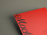 Red poster/letterhead mockup on a grey paper stock background top view.