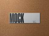 Ticket/invitation card mockup on a cardboard background top view.